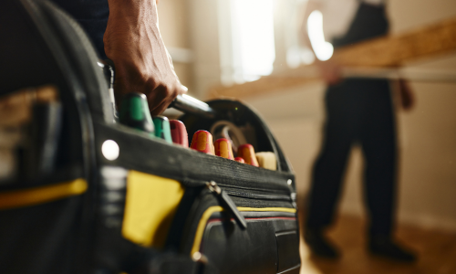A close-up of a contractors tool bag.